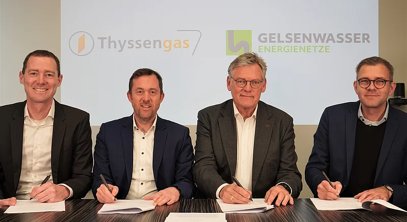 Vertreter von Thyssengas und Gelsenwasser Energienetze bei der Vertragsunterzeichnung vor einer Logowand.
